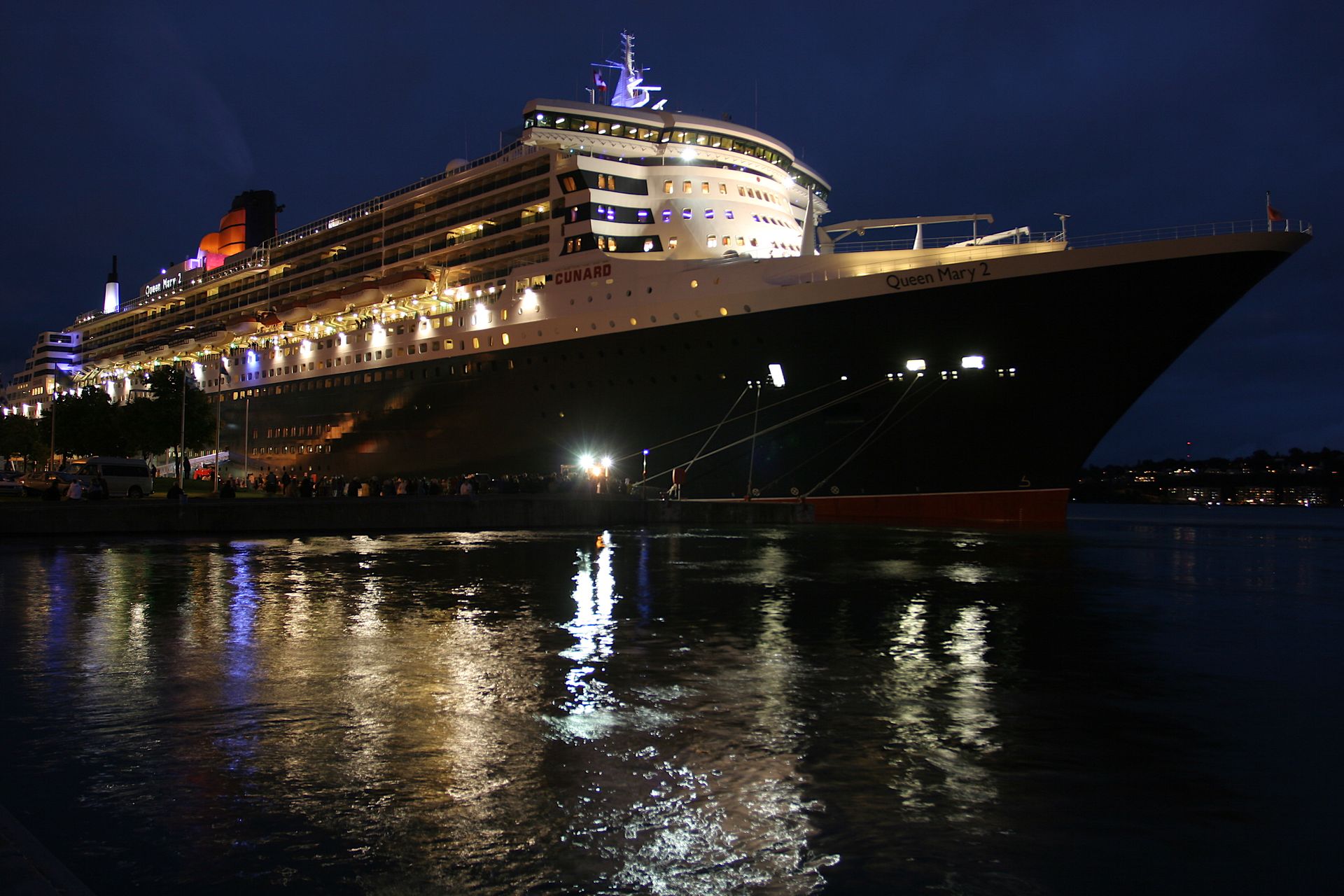 Cunard's Queen Mary 2 in port at Quebec City, lit up at night.